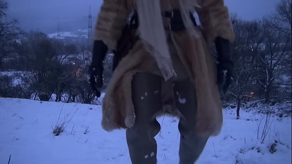 Bitch in the snow with long rubberboots on the feet