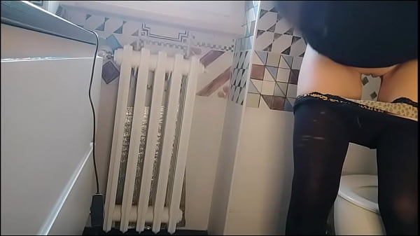 Chantal has not yet realized that I am spying on her from behind the door while she is on the toilet. And I film it