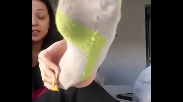 He takes off his sock and shows his foot
