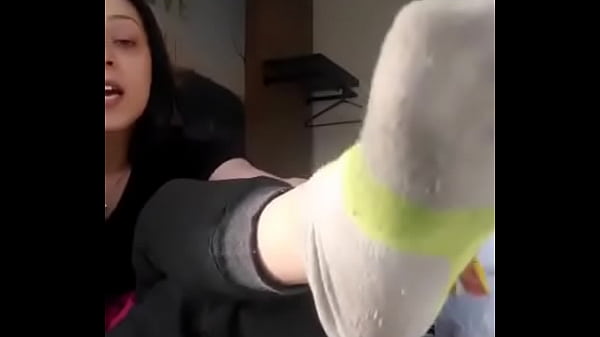 He takes off his sock and shows his foot