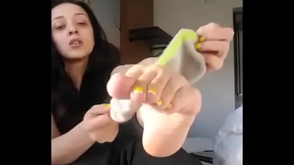 He takes off his sock and shows his foot