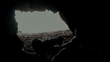 Couple recorded at the beach, inside the cave