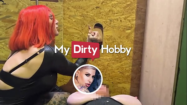 Busty redhead jerking hard cocks in