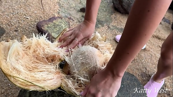 Naked girl found a coconut on a public beach and poured the juice over her body