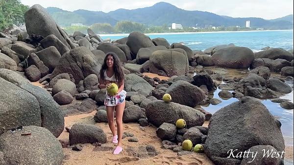 Naked girl found a coconut on a public beach and poured the juice over her body