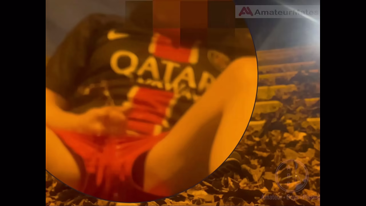 Amateur boy in football gear and sneakers caught wetting himself in the street