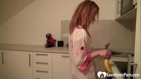 Beauty sucks on a banana while naked