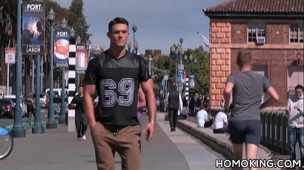 Hot guy picking up and blowing off a muscular m...