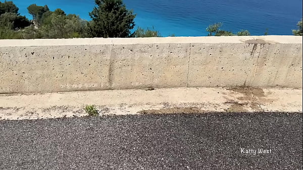 Shameless girl pissing standing on the background of the sea