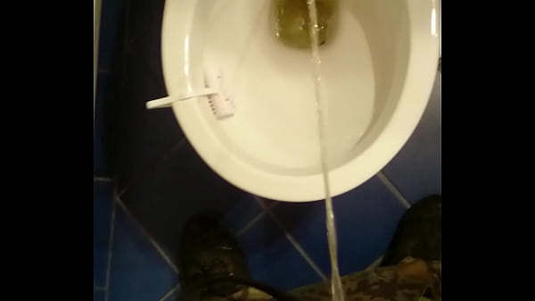 Guy pissing in toilet