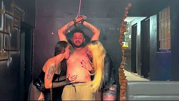 Two beautiful dominatrixes, and the submissive getting a spanking while being obedient.