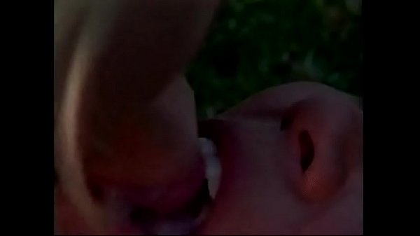 Two lustful chicks with young beautiful bodies caress each other on the lawn