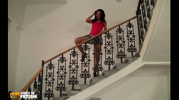 Naughty teen masturbates on the stairs while a man watches her