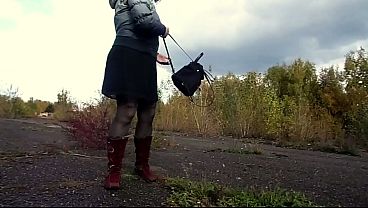 Outdoor pissing. A MILF urinates while walking in a public park and by the sea.