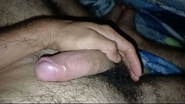 Playing quietly with my big cock under the sheets