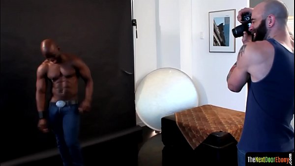 Ebony hunk cocksucking during photo shoot