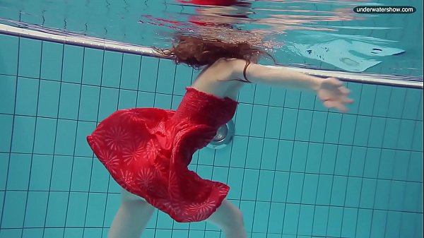 Red Dressed teen swimming with her eyes opened