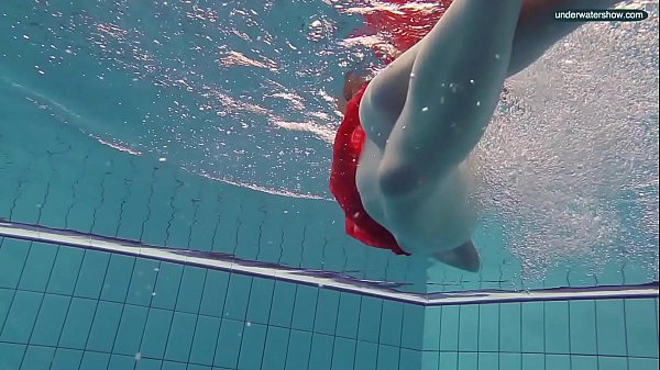 Red Dressed teen swimming with her eyes opened