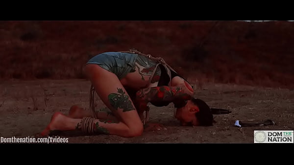 Ass eating bondage slave cries while her feet get caned outdoors in the dirt - Rocky Emerson