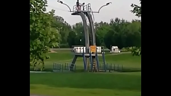 Couple having sex on city baths jumping board