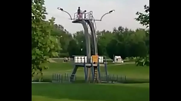 Couple having sex on city baths jumping board