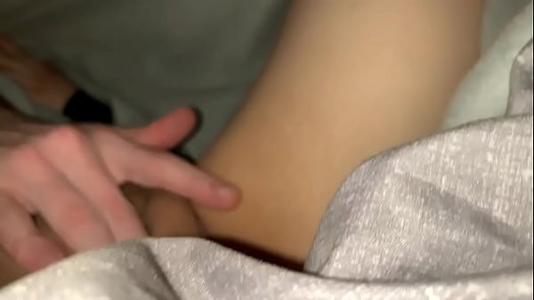 Rubbing her pussy on the couch under the sheets.