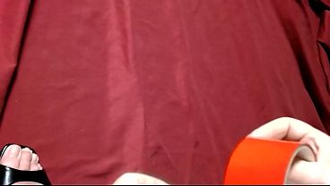 A girl tied up with red duct tape and gagging during a photo shoot