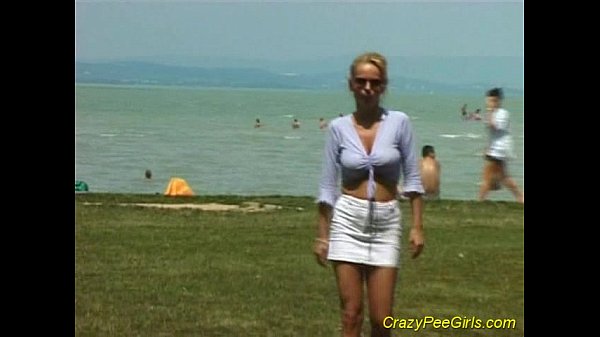 Crazy pee girl on the beach