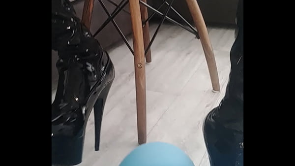 Veve performs balloon popping in latex stockings with a sharp