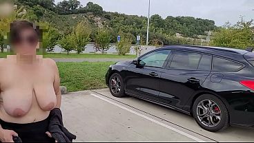 A busty milf topless on the road.