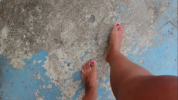 Foot fetish with dirty, wet and bare feet on the street