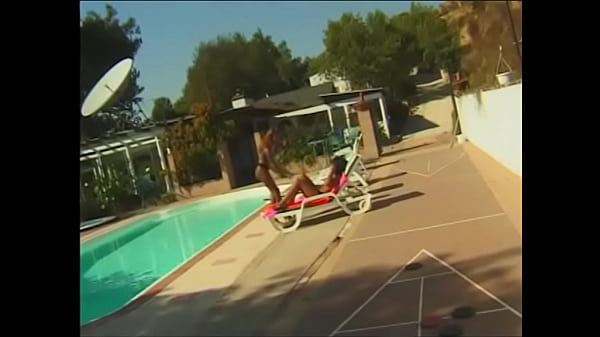 A red-haired bitch with a round ass and a brunette with big melons are passionately engaged in lesbian sex on a sun lounger and by the pool, licking each other's pussies