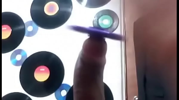 Bi Teen boy playing with fidget spinner toy