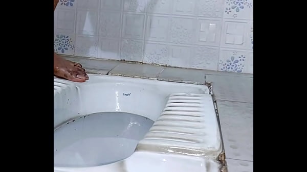 Caged sissy slave pissing outdoor while plugged