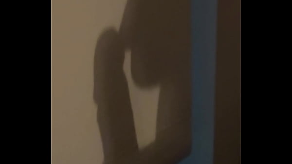 The shadow reflects her sucking his cock