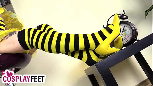 Cosplayer lility is dressed as a bee today, with black and yellow striped stockings, yellow high heels and a tiny costume. She takes off her heels, then her stockings, and starts playing with feet and legs, showing off her flexible skills