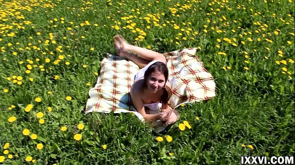 Beautiful teen Ananta Shakti masturbates her pussy on a field with dandelions