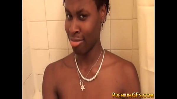 Busty bathing ebony fingers her pussy