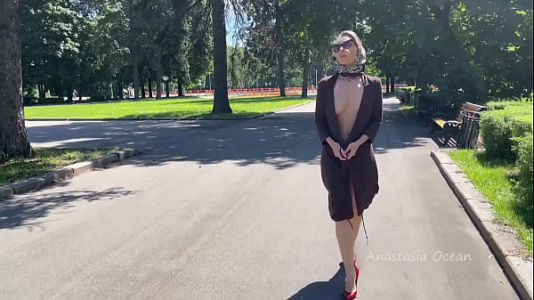 Stylish Lady walks naked in park. Public