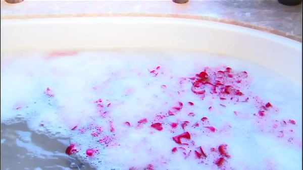 Steamy session with blond and dude in sudsy and rose petal filled tub.