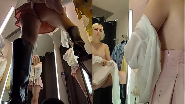 Upskirt view in public fitting room on pussy of blonde with big tits