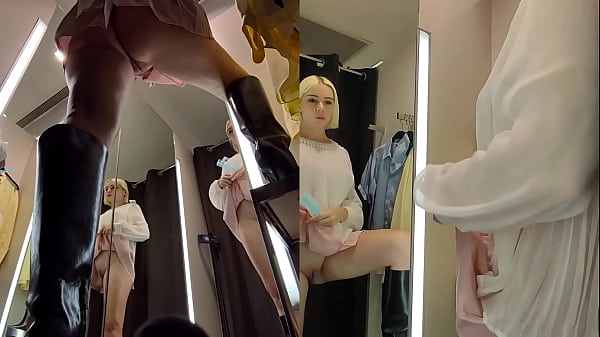 Upskirt view in public fitting room on pussy of blonde with big tits