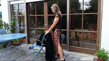 A mature woman shows off her figure outside in a lace bodysuit!