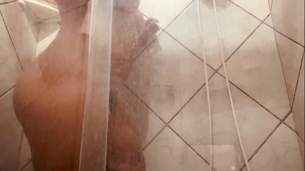 Girl being filmed while taking a shower, showing off her hairy pussy.