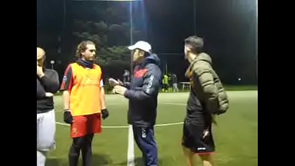 Hot sweaty football player grabbing cock while spitting on the grass
