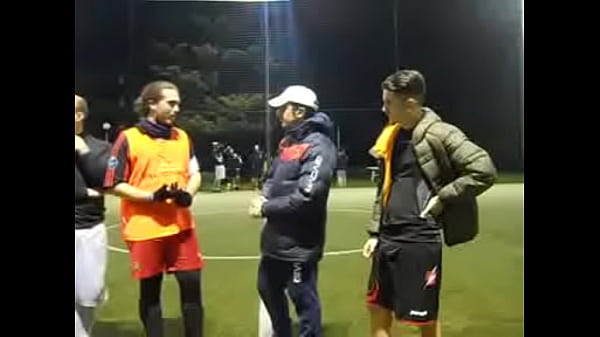 Hot sweaty football player grabbing cock while spitting on the grass