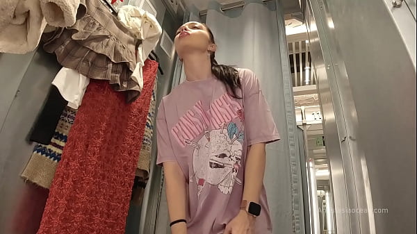I try on clothes in fitting room with open curtain.