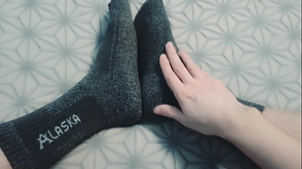 A guy massages his legs with oil