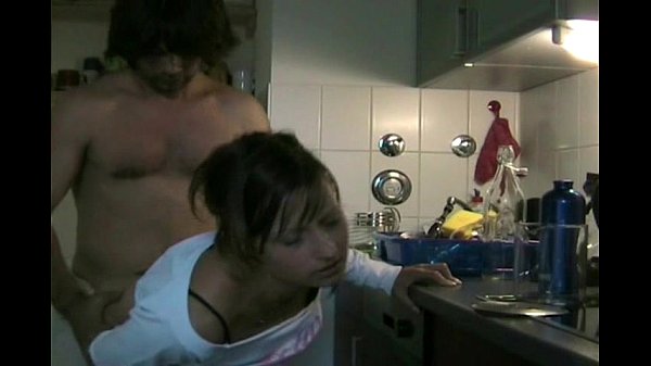Couple having sex in kitchen