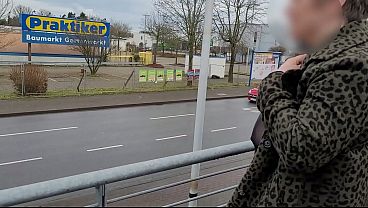A milf with a sheer top exposed her big tits in the street.